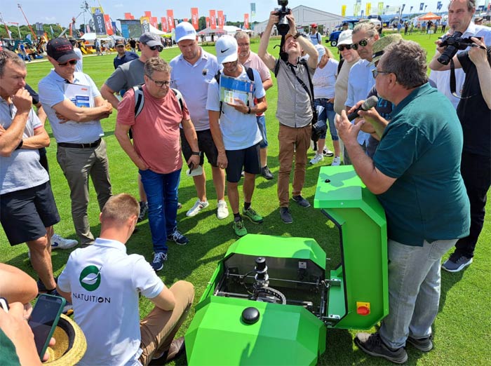 Großes Interesse fand der Rasenroboter VIOLETTE, der zur mechanischen Unkrautbekämpfung im Rasen eingesetzt werden kann. Hier aufmerksame Zuhörer bei den Erläuterungen von Frank Hemmerich.